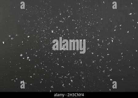 Confetti or artificial snow on black background Stock Photo