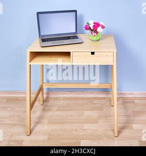 Wooden console table with laptop which stands on it. Stock Photo