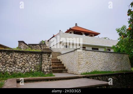 Building exterior of other part or section of Balinese hindu Uluwatu temple in Bali Indonesia with clear blue sky background. No people.