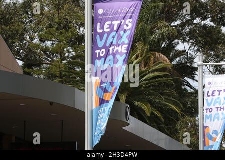 Sydney, Australia. 28th October 2021. City of Ryde Council in north west Sydney has put banners with the slogan ‘Let’s Vax to the Max’ to try to convince people to get vaccinated. Pictured is a banner in the Sydney suburb of Eastwood. Credit: Richard Milnes/Alamy Live News Stock Photo