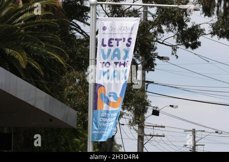 Sydney, Australia. 28th October 2021. City of Ryde Council in north west Sydney has put banners with the slogan ‘Let’s Vax to the Max’ to try to convince people to get vaccinated. Pictured is a banner in the Sydney suburb of Eastwood. Credit: Richard Milnes/Alamy Live News Stock Photo