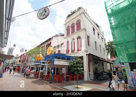 Pagoda street with old shophouses and several people walking in Singapore's Chinatown district. Stock Photo
