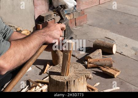 Man chopping wood with an ax. Stock Photo