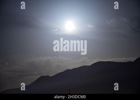 Full moon and grand mountain (uludag) silhouette at middle of the night in bursa Turkey Stock Photo