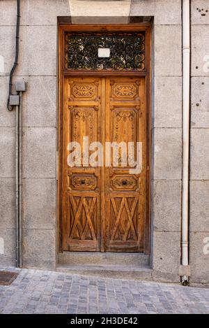 Wooden entrance door to a stone building over 100 years old in a European city Stock Photo