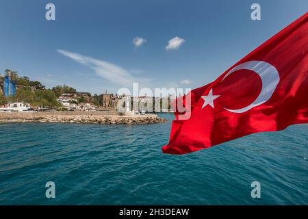 Tourist tour on a boat crossing the waters of the Mediterranean with a Turkish flag flying at the stern Stock Photo