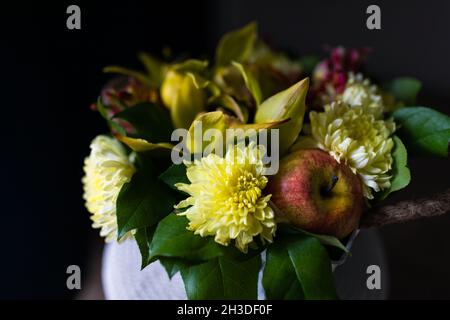 Bouquet of yellow chrysanthemums with apple, fresh flowers, artificial apple. Stock Photo