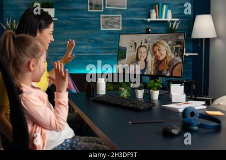 Woman discussing with remote friends during online videocall meeting ...