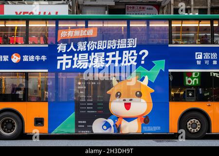 Hong Kong, China. 18th Oct, 2021. A bus displays a commercial advertisement of the digitized brokerage and wealth management platform Futu Holdings in Hong Kong. Credit: SOPA Images Limited/Alamy Live News Stock Photo