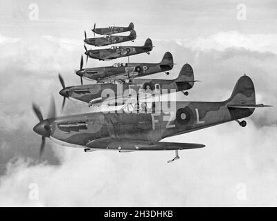 Airplane history. British fighter aircrafts, Supermarine Spitfire in the air, one in front of the other. Stock Photo