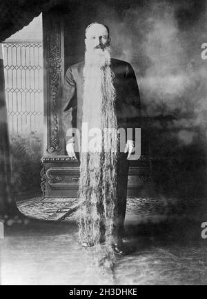 Zacharias T. Wilcox from Carson City Nevada. Famous for having a beard that is more than two meters long. He is pictured standing with the beard hanging from his head down to the floor. He was in 1922 part of a American nationwide search for the man with the longest beard and came in second-place with a length of  his beard at 12 feet. Stock Photo