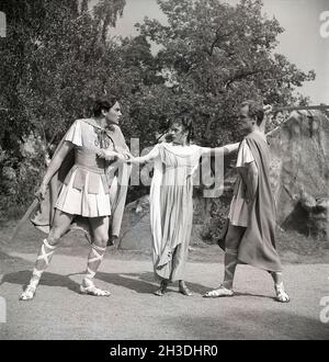 In the theatre in the 1940s. An outdoor theatre of the play A Midsummer Night's dream  written by William Shakespeare. A woman stands between two men who looks angrily at each other holding swords. Sweden 1946. ref U47-5 Stock Photo