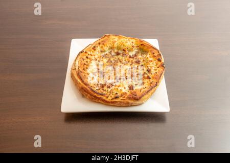 Garlic bread cake with minced meat, oregano, olive oil and mozzarella cheese Stock Photo