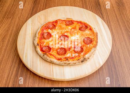 Small Italian pizza with melted mozzarella cheese and spicy pepperoni slices Stock Photo