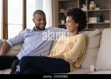 Happy young african american family couple talking at home. Stock Photo
