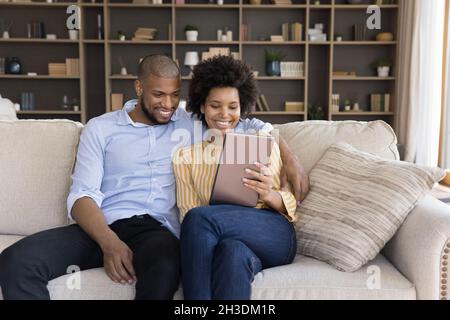 Happy young african american couple using tablet. Stock Photo