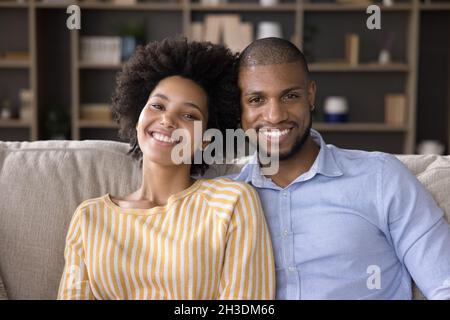 Portrait of happy relaxed young african american family couple. Stock Photo