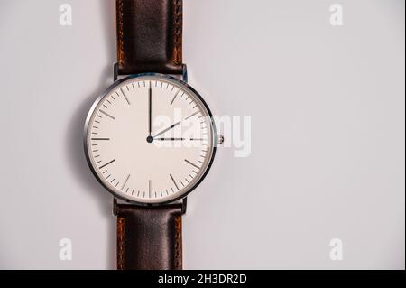Daylight Saving Time (DST) concept for changing clocks one hour back or forward seasonally. Wrist watch showing 2 a.m. and 3 a.m. Stock Photo