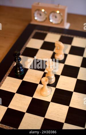 Chessboard with chess figures and chess clock Stock Photo