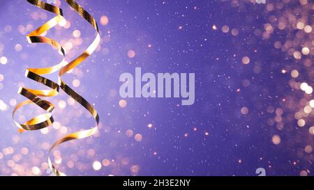 Celebration party background with a golden streamer, glitter, sparks and lights bokeh Stock Photo