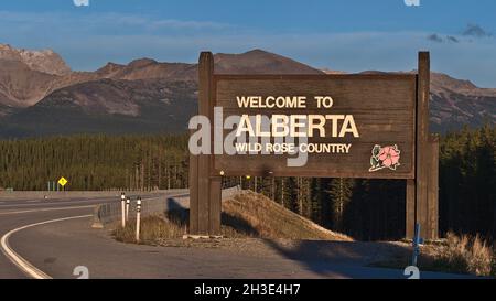 Welcome sign of Canadian province Alberta, the wild rose country, at the border to British Colombia in the evening sunlight in the Rocky Mountains. Stock Photo