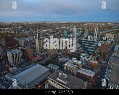 Aerial view of northeastern Calgary downtown with theatre, Olympic Plaza, city hall and municipal building and Bow River in the evening in autumn. Stock Photo