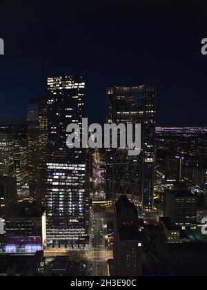 Stunning high angle view of Calgary downtown at night with illuminated buildings Suncor Energy Centre, Telus Sky and The Bow (from left to right). Stock Photo