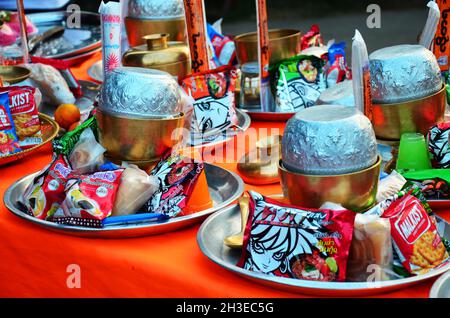 Offering almsgiving food set for thai people respect praying and put sacrificial to monks walk on street of Songkalia local village at Sangkhla Buri c Stock Photo