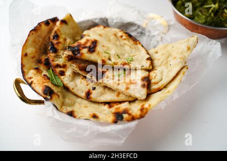 Fresh Tandoori Roti or Butter Naan isolated on white, selective focus Stock Photo