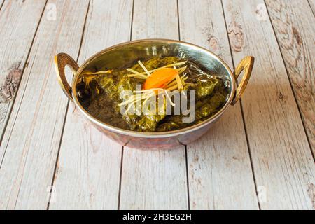 Palak paneer is an Indian cuisine dish consisting of spinach and Paneer cheese in a curry sauce. Palak paneer is a type of Saag, which can also be mad Stock Photo