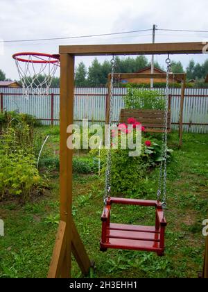 homemade wooden swings in the village, in the summer Stock Photo
