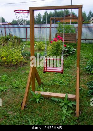 homemade wooden swings in the village, in the summer Stock Photo