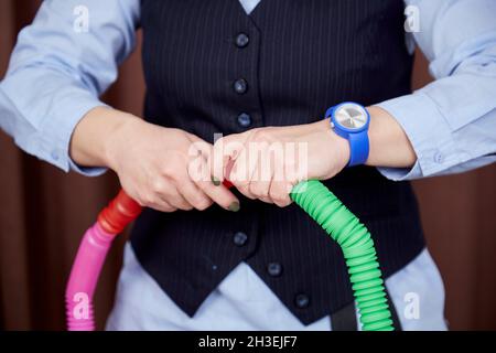 The child psychologist shows a new trend in the Pop tube toy. Colorful popular anti-stress sensory toy. Fashionable anti-stress toy for the development of fine motor skills. High quality photo Stock Photo