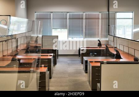 Houston, Texas USA 10-24-2021: Empty office cubicles with clear plastic partitions to protect from Covid-19. Work from home concept due to the coronav Stock Photo