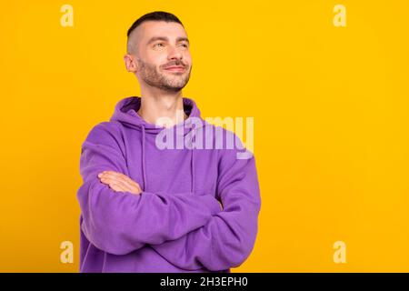 Portrait of attractive dreamy content cheerful guy folded arms thinking copy space isolated over vivid yellow color background Stock Photo