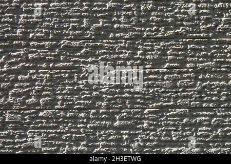 Texture of the building wall made of fine gray stone. Stock Photo