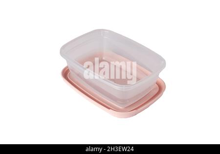 Open plastic food storage container with pink lid isolated on white background. Food box for lunch. Close up Stock Photo