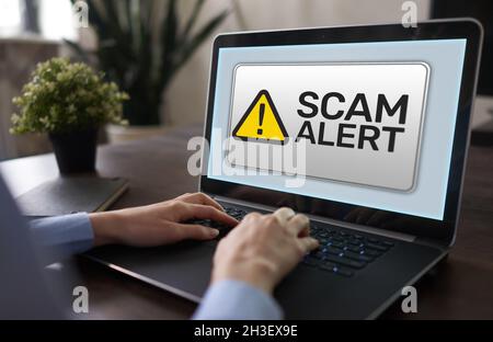 Scam alert detecting warning. Notification on device screen. Stock Photo