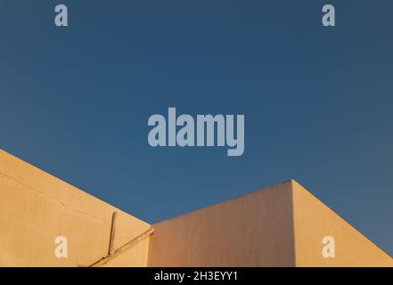 White buildings against blue sky during sunrise Stock Photo