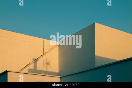 White buildings against blue sky during sunrise Stock Photo