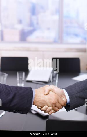 Businessmen handshake over table Stock Photo