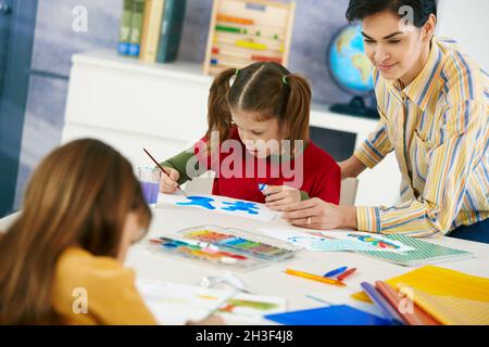 Children painting in art class at elementary school Stock Photo