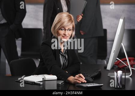 Businesswoman using calculator Stock Photo