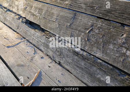 The old boards that constituting the sides and the bottom of the wagon create a background of transience. The weathered boards changed color due to ch Stock Photo