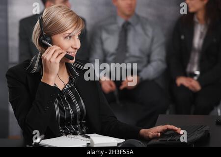 Businesswoman using headset Stock Photo