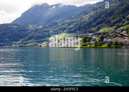 Residential buildings located on the slope of the hill on the edge of Lake Lucerne are visible at a distance. The Lake of the four Cantons. Stock Photo