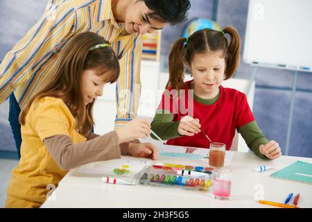 Children painting in art class at elementary school Stock Photo