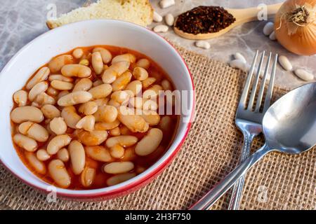 Traditional Turkish food Kuru Fasulye. Hot Turkish bean in bowl. Top view food presentation. Stock Photo