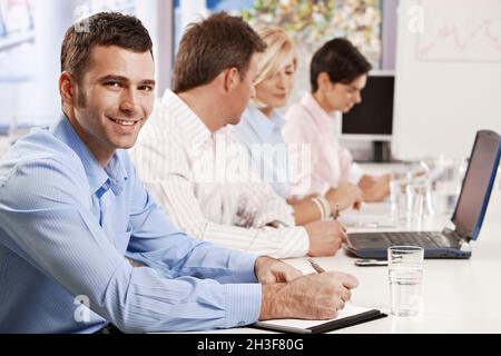 Businessman making notes on presentation Stock Photo