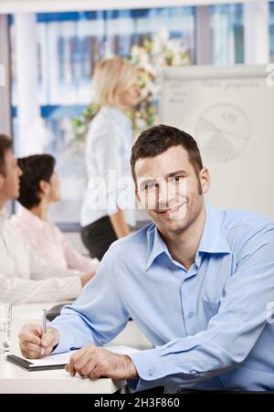 Businessman making notes on meeting Stock Photo